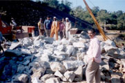excavation of blasted rock debris by use of trolley crane and transporting it to the dumping grounds